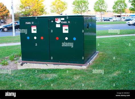 green electric box on street|green electrical box in street.